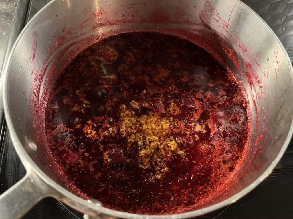 Orange zest in cranberry sauce in a pot